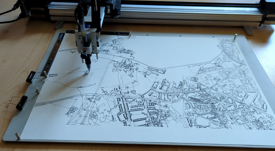 Image of pen plotter plotting a map.